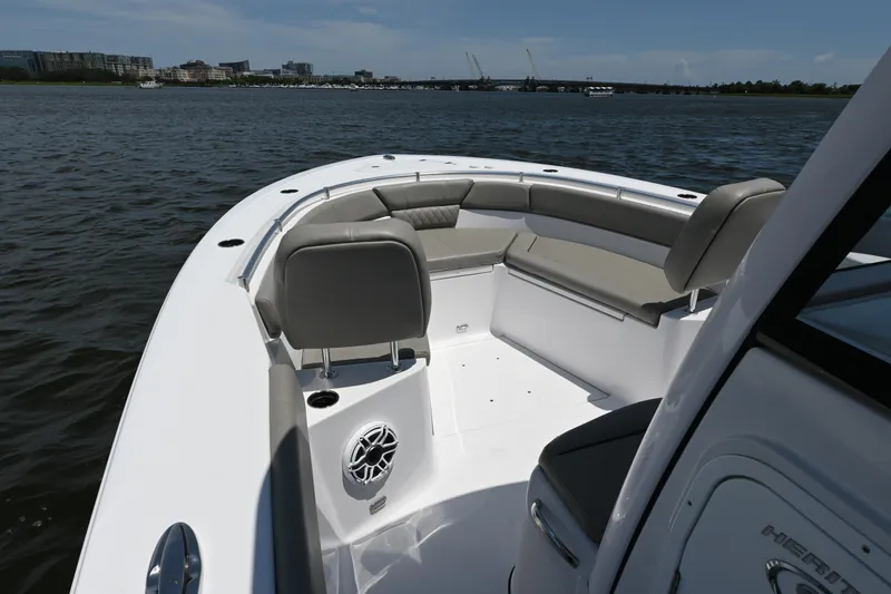 Slide: The Image of 2025 Sportsman Heritage 261 Center Console boat interior with seating, on calm water. - 22