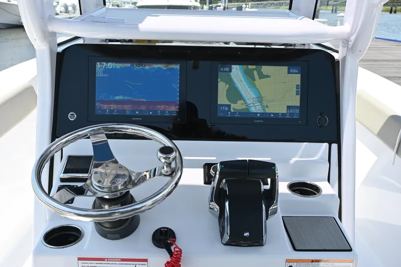 Slide: The Image of 2025 Sportsman Heritage 261 Center Console dashboard with dual Garmin displays and steering wheel. - 7