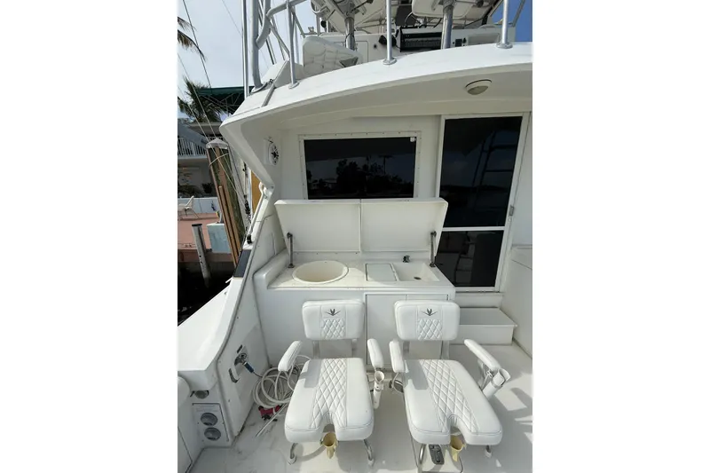 Slide: The Image of 1989 Bertram 43 Convertible yacht deck with seating and fishing station. - 28