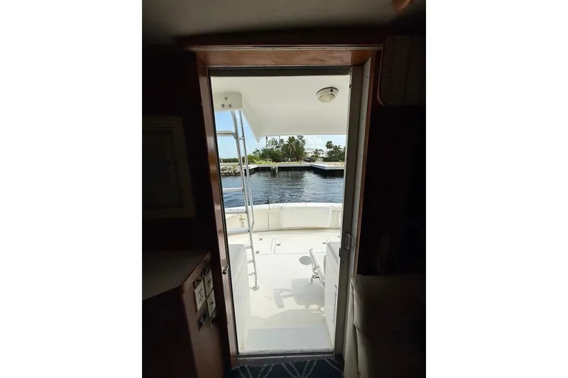 Slide: The Image of Interior view from a 1989 Bertram 43 Convertible yacht, overlooking the deck and water. - 31