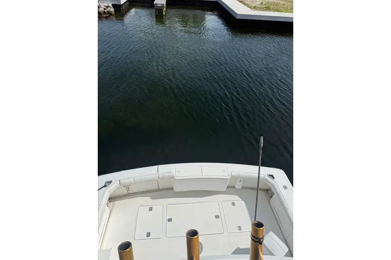 Slide: The Image of 1989 Bertram 43 Convertible boat deck overlooking calm water. - 57
