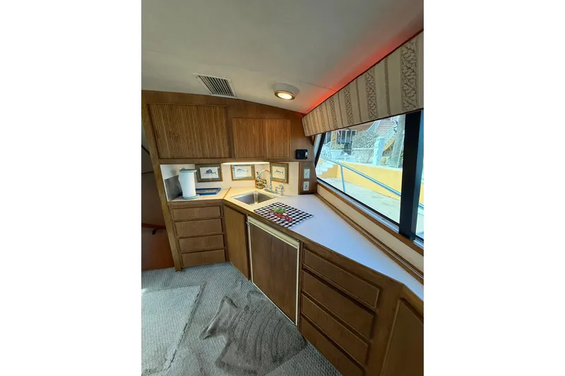 Slide: The Image of Interior of 1989 Bertram 43 Convertible yacht with wooden cabinetry and countertop. - 36