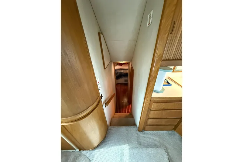 Slide: The Image of Interior view of 1989 Bertram 43 Convertible yacht, featuring wooden stairs and cabinetry. - 40