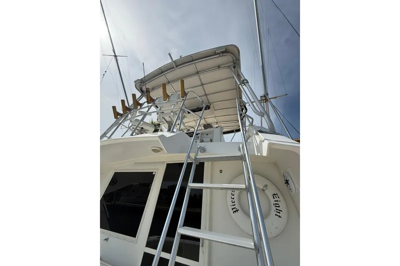 Slide: The Image of 1989 Bertram 43 Convertible yacht with ladder and upper deck view. - 47