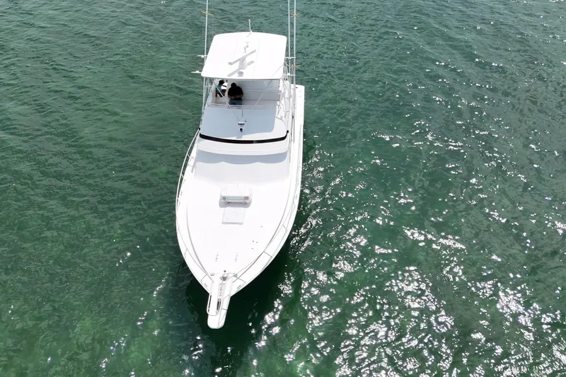 Slide: The Image of Aerial view of 1989 Bertram 43 Convertible yacht on clear green water. - 16