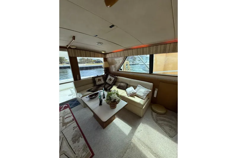 Slide: The Image of Interior of 1989 Bertram 43 Convertible yacht with cozy seating and decorative pillows. - 39