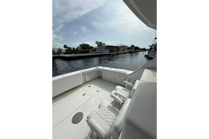 Slide: The Image of 1989 Bertram 43 Convertible yacht with spacious deck and waterfront view. - 24