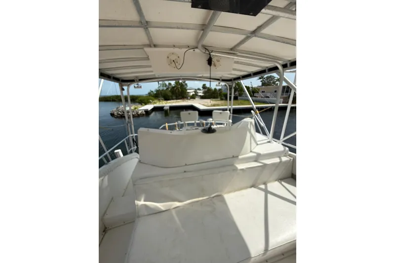 Slide: The Image of 1989 Bertram 43 Convertible boat interior with seating and water view. - 55