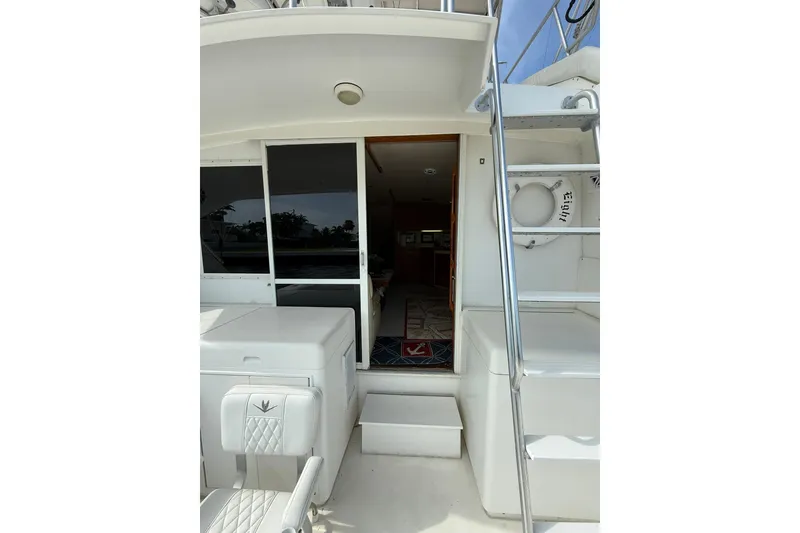 Slide: The Image of 1989 Bertram 43 Convertible yacht interior view with seating and ladder. - 30