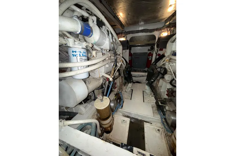 Slide: The Image of Engine room of a 1989 Bertram 43 Convertible boat, showcasing mechanical components. - 58