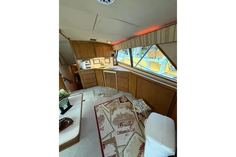 Slide: The Image of Interior of 1989 Bertram 43 Convertible yacht with wood cabinetry and nautical decor. - 34