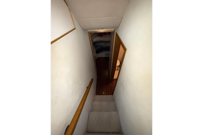 Slide: The Image of Staircase leading to cabin interior of 1989 Bertram 43 Convertible yacht. - 42