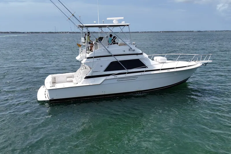 Slide: The Image of 1989 Bertram 43 Convertible yacht cruising on open water. - 9