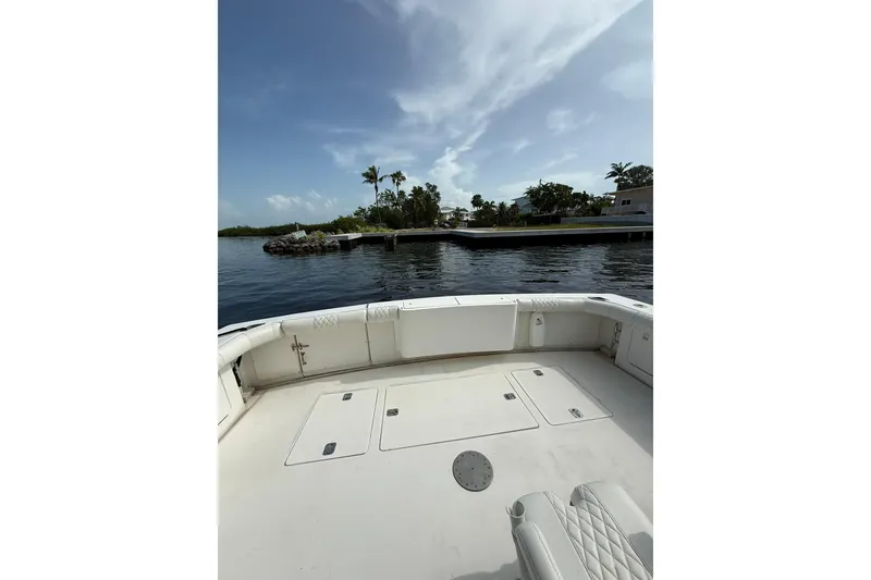 Slide: The Image of 1989 Bertram 43 Convertible boat deck with scenic waterfront view. - 23