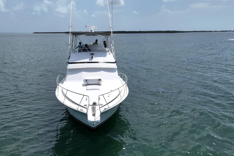 Slide: The Image of 1989 Bertram 43 Convertible yacht cruising on open water. - 12