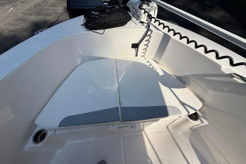 Slide: The Image of 2022 Robalo R180 Center Console boat interior with cushioned seating and storage. - 25