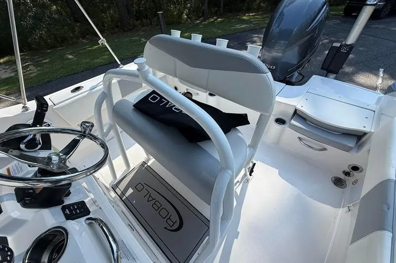 Slide: The Image of 2022 Robalo R180 Center Console boat interior with steering wheel and seating. - 13