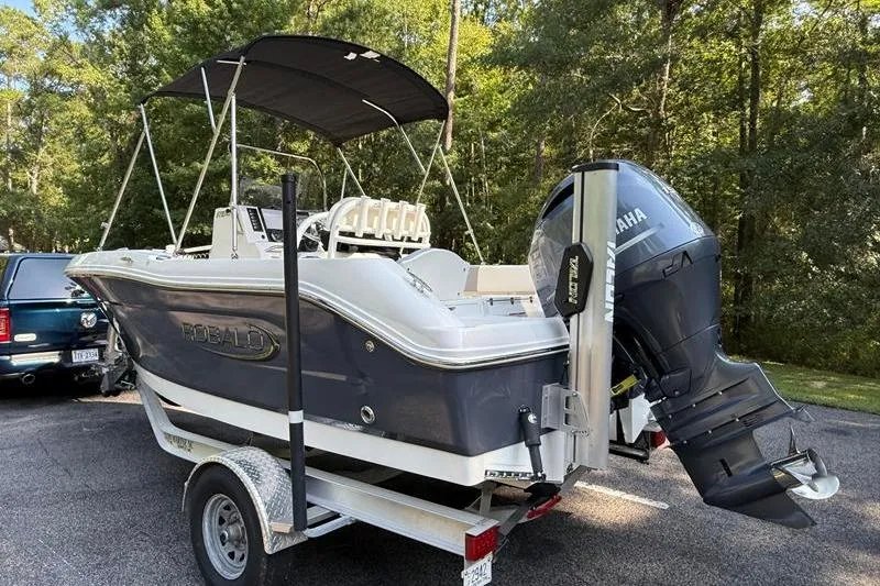 Slide: The Image of 2022 Robalo R180 Center Console boat on trailer with Yamaha outboard motor. - 2