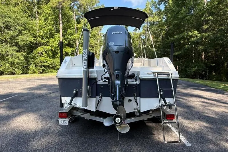Slide: The Image of 2022 Robalo R180 Center Console boat with outboard motor, parked on a sunny day. - 3