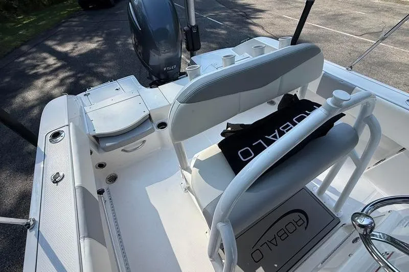 Slide: The Image of 2022 Robalo R180 Center Console boat interior with seating and engine view. - 14