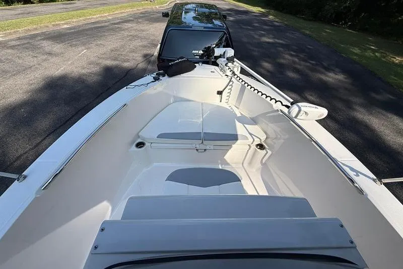 Slide: The Image of 2022 Robalo R180 Center Console boat on trailer, parked on a paved road. - 22