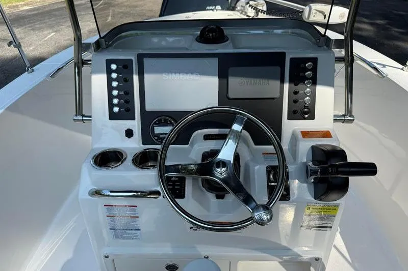 Slide: The Image of 2022 Robalo R180 Center Console dashboard with steering wheel and controls. - 12
