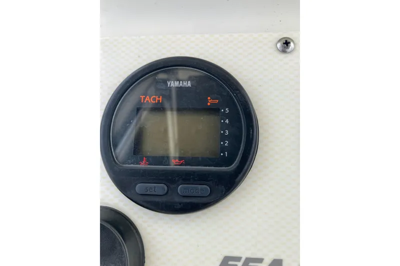 Slide: The Image of Yamaha tachometer on 2003 Seapro 239 boat dashboard, displaying RPM gauge. - 7