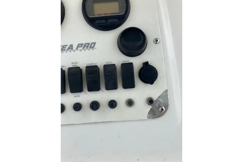 Slide: The Image of Control panel of a 2003 Seapro 239 boat with switches and gauges. - 5