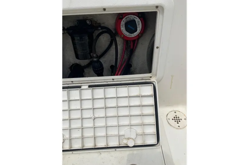 Slide: The Image of Open compartment of a 2003 Seapro 239 boat showing wiring and components. - 16