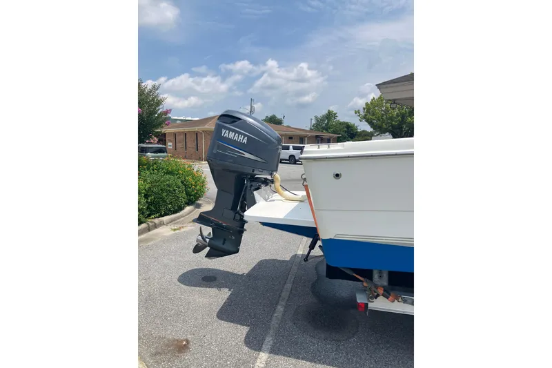 Slide: The Image of 2003 Seapro 239 boat with Yamaha outboard motor in parking lot. - 21