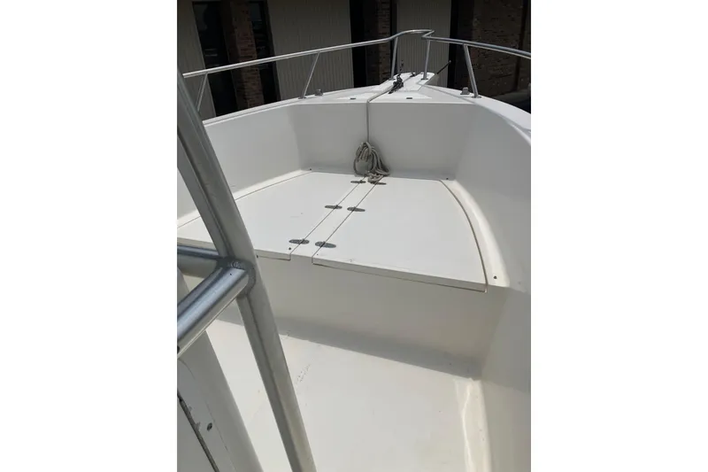 Slide: The Image of 2003 Seapro 239 boat deck with railing and storage compartment. - 15