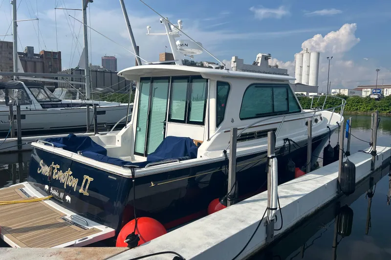Slide: The Image of 2024 Back Cove 372 yacht docked at marina, featuring sleek design and modern amenities. - 2