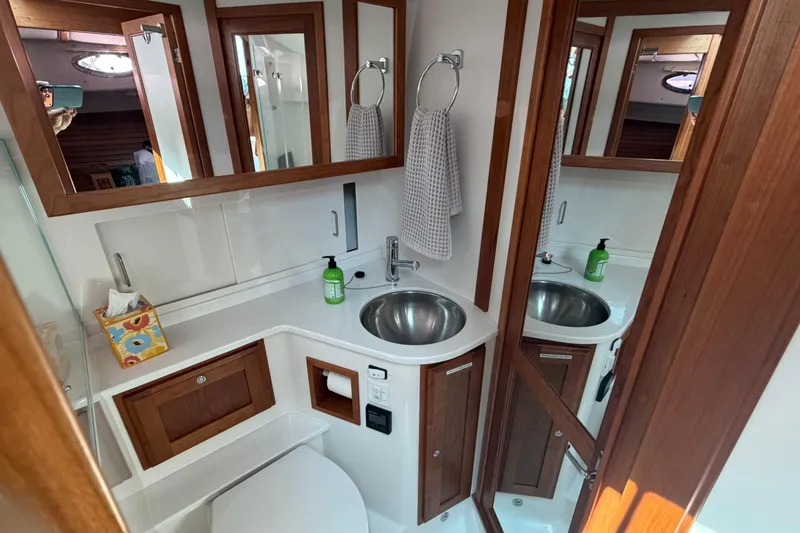 Slide: The Image of Luxurious 2024 Back Cove 372 yacht bathroom with modern fixtures and wooden accents. - 34