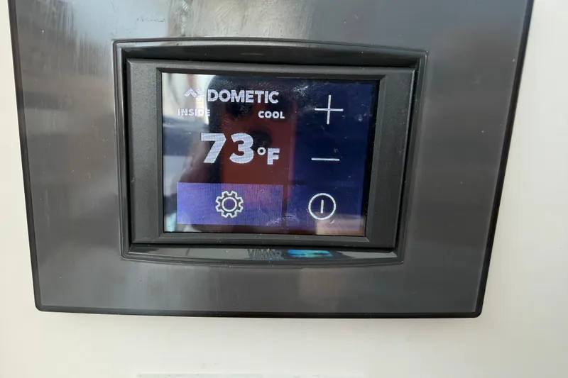 Slide: The Image of Dometic thermostat displaying 73°F on a 2024 Back Cove 372 yacht. - 52