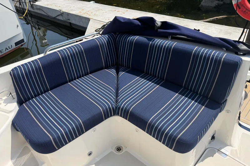 Slide: The Image of 2024 Back Cove 372 boat with blue striped seating at dockside. - 73