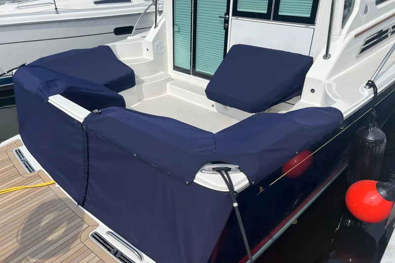 Slide: The Image of 2024 Back Cove 372 boat with navy blue seat covers and deck view. - 14