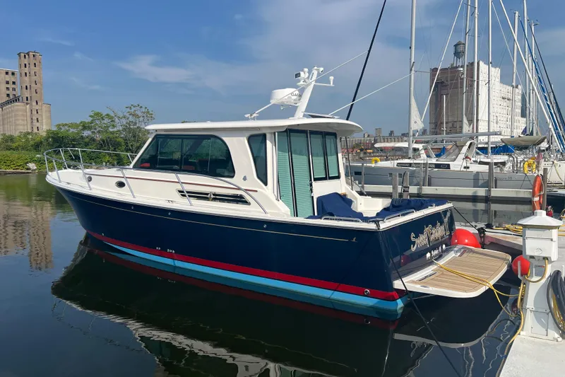 The Image of 2024 Back Cove 372 yacht docked in a marina under a clear blue sky. - 0