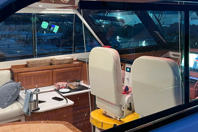 Slide: The Image of Interior view of 2024 Back Cove 372 yacht, featuring elegant seating and navigation equipment. - 16