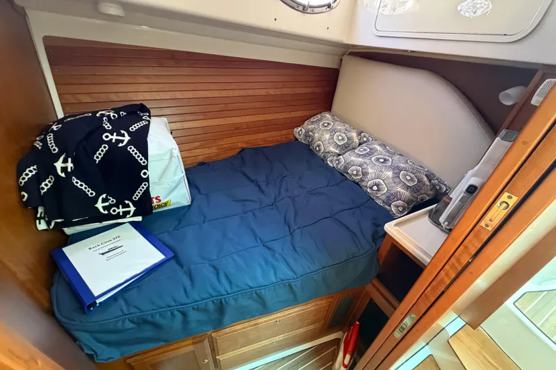 Slide: The Image of Cozy cabin interior of 2024 Back Cove 372 boat with bed and nautical decor. - 33