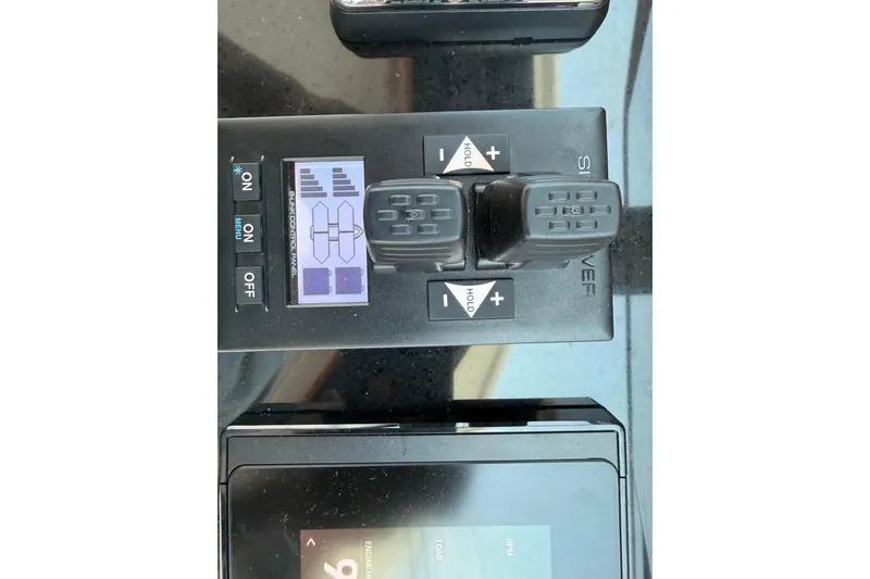 Slide: The Image of Control panel of a 2024 Back Cove 372 boat with joystick and display. - 49