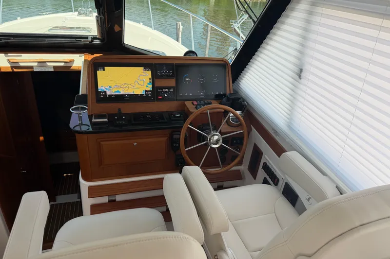 Slide: The Image of 2024 Back Cove 372 helm with navigation screens and leather seating. - 58