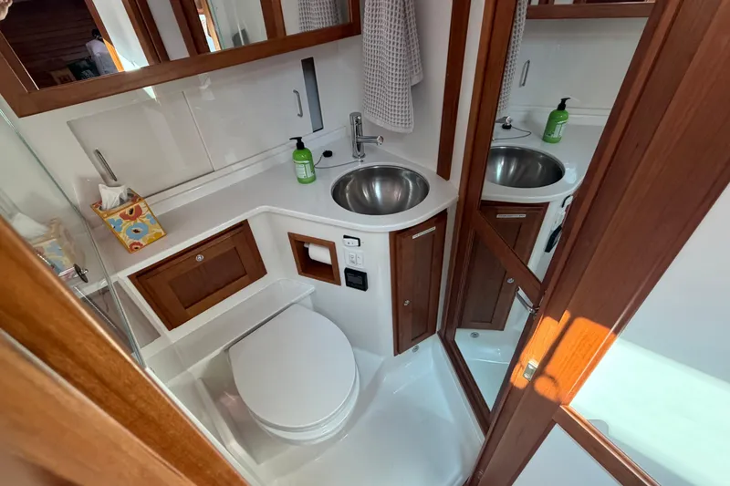 Slide: The Image of 2024 Back Cove 372 yacht bathroom with modern fixtures and wooden cabinetry. - 35