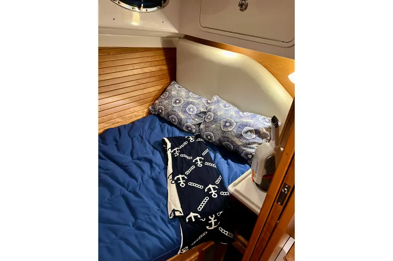 Slide: The Image of Cozy cabin interior of 2024 Back Cove 372 with nautical-themed bedding. - 27