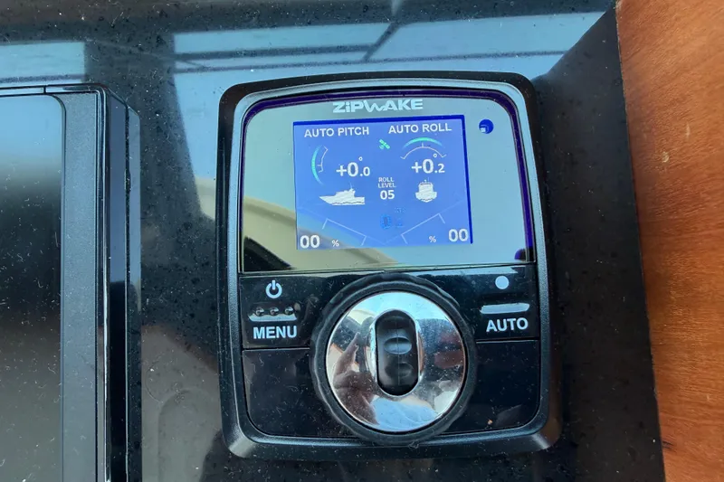 Slide: The Image of Zipwake control panel on 2024 Back Cove 372 boat, displaying auto pitch and roll settings. - 43