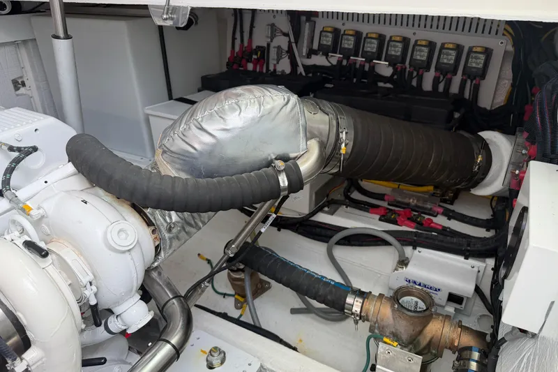 Slide: The Image of Engine room of 2024 Back Cove 372 boat, showcasing mechanical components and wiring. - 83