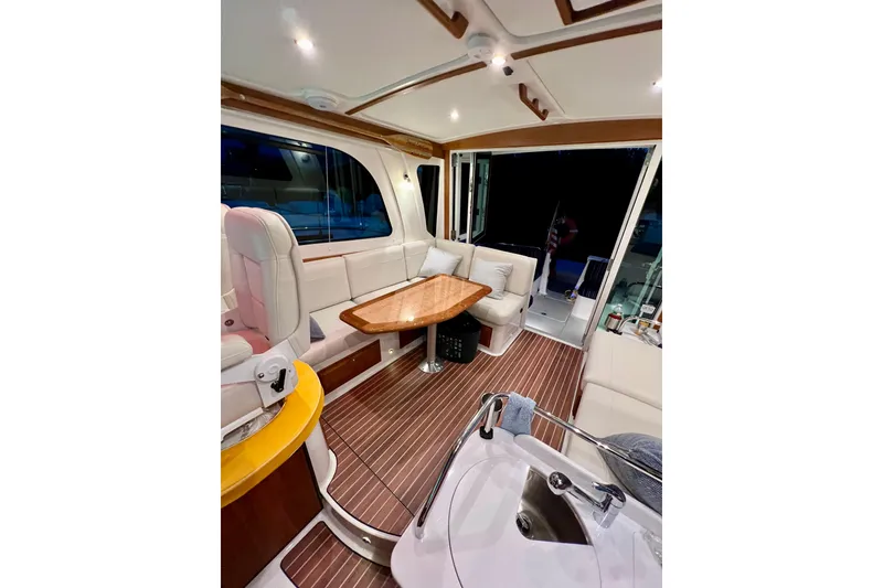 Slide: The Image of Luxurious interior of 2024 Back Cove 372 yacht with elegant seating and wooden table. - 25