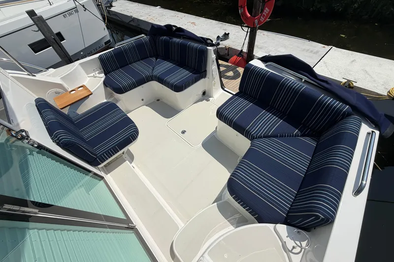 Slide: The Image of 2024 Back Cove 372 boat with striped seating in a spacious deck area. - 74