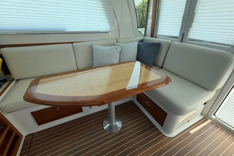 Slide: The Image of 2024 Back Cove 372 interior with elegant seating and wooden table, featuring modern design and comfort. - 57