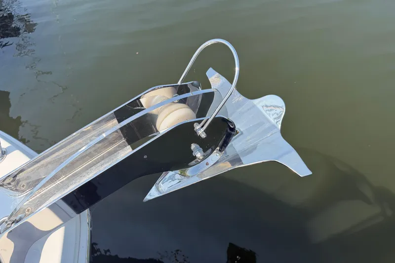 Slide: The Image of Anchor detail of 2024 Back Cove 372 boat, reflecting on calm water. - 66