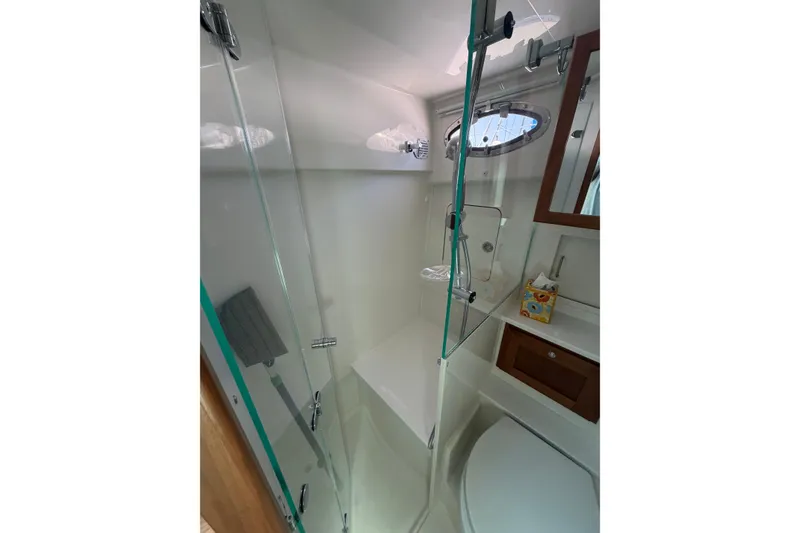 Slide: The Image of Bathroom interior of 2024 Back Cove 372 yacht with glass shower and wooden accents. - 36
